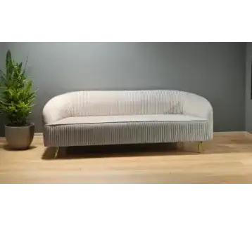 Large circular sofa upholstered in luxurious fabric with golden legs for rent | Estajer